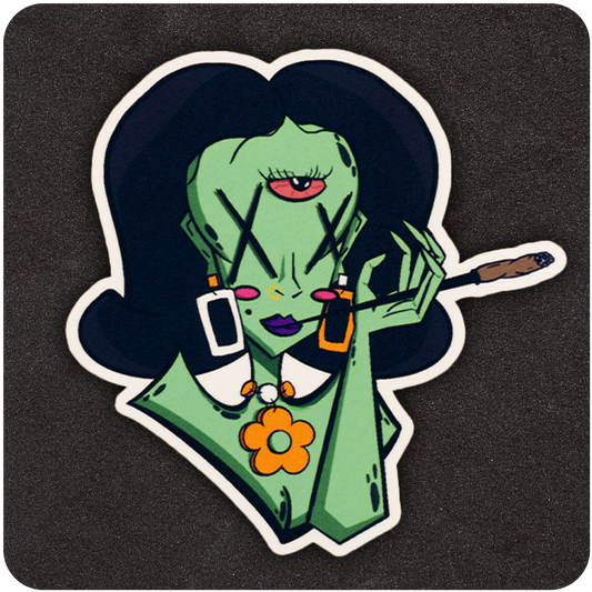 A vinyl sticker of a green-skinned, cartoon-style female alien with three eyes—two marked by bold Xs and one centered on her forehead. She has voluminous dark hair and wears bold geometric earrings, a white collar with orange flower accessories, and purple lipstick. She holds a joint in her right hand with a relaxed expression. The sticker is set against a textured black background.