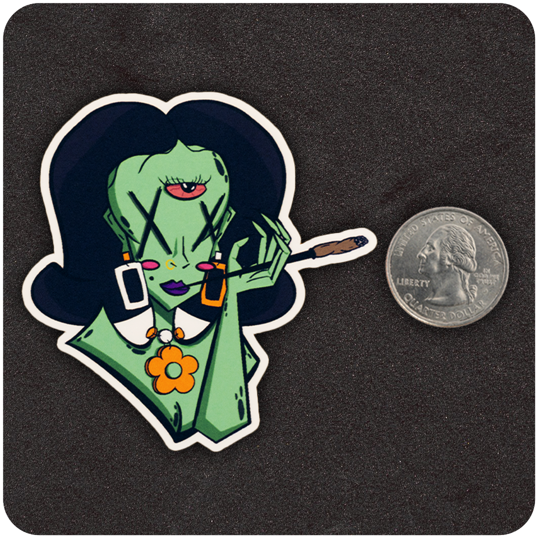 The Casual Covert Beanie vinyl sticker next to a quarter to show scale.