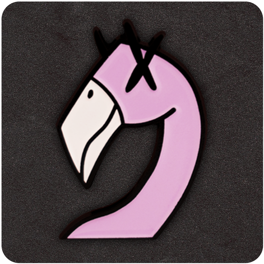 Close-up of a pink flamingo-shaped enamel pin with cartoon-style design and X-marked eyes, outlined in black, displayed against a dark textured background.