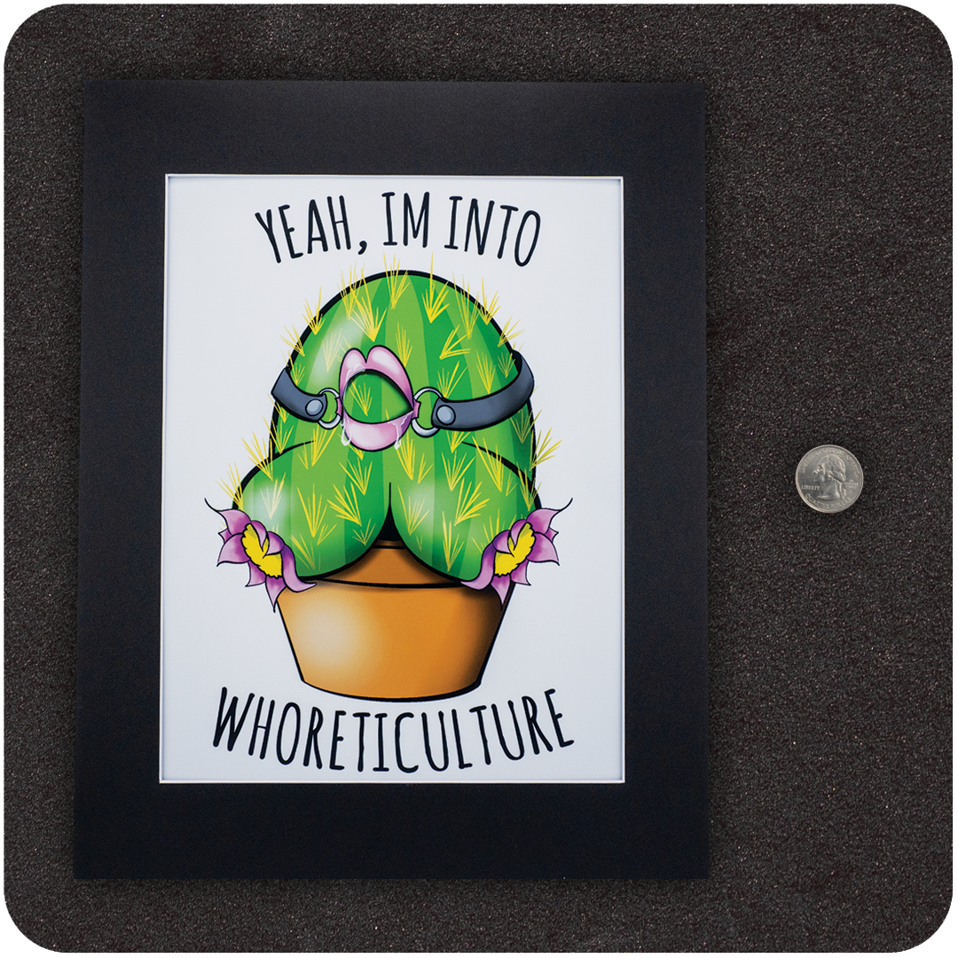 Framed art print featuring a cartoon cactus shaped like a curvy backside with a pink ball gag and leather harness, planted in a pot with purple flowers. Above and below the cactus, the text reads “Yeah, I’m Into WHORETICULTURE.” Displayed on a black background next to a U.S. quarter for scale.