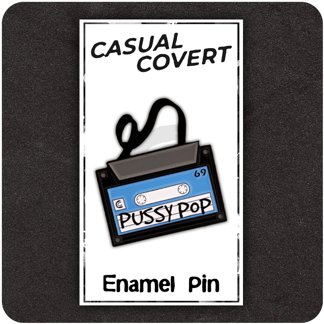 Pussy Pop Mixtape enamel pin on Casual Covert backing card, shaped like a retro cassette tape with black spooled ribbon and bold handwritten lettering.
