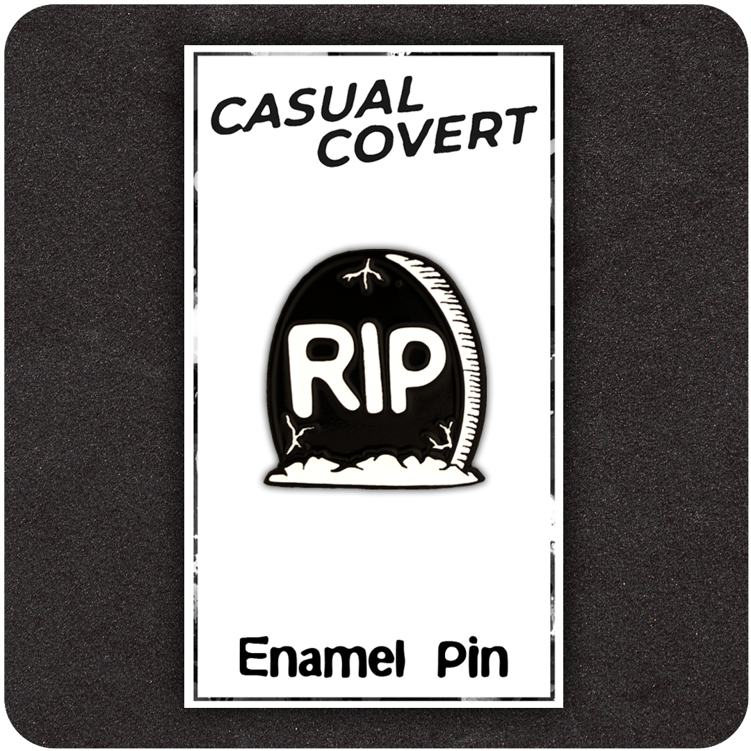 The Casual Covert RIP Enamel Pin with its backing card showing how the pin is packaged.