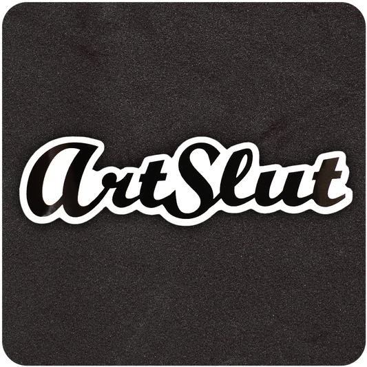 A glossy black die-cut vinyl sticker featuring the bold, stylized script text “ArtSlut.” The typeface is a flowing cursive with thick lines and a modern flair, outlined in white for contrast. The sticker is placed on a textured black background, emphasizing its sleek design and edgy, artistic statement.