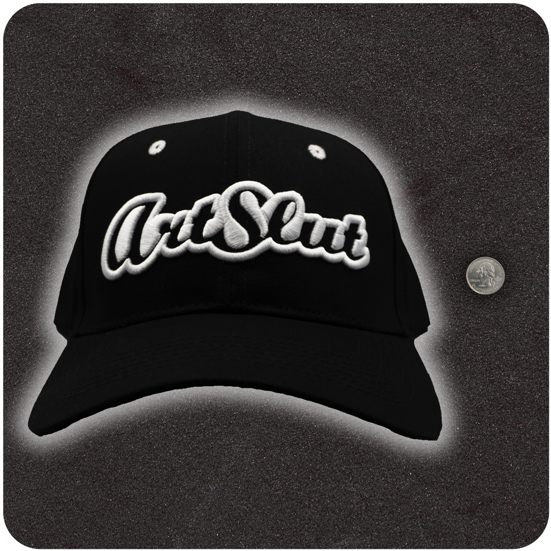 Casual Covert Art Slut Snapback Hat shown next to a quarter for relative scale.