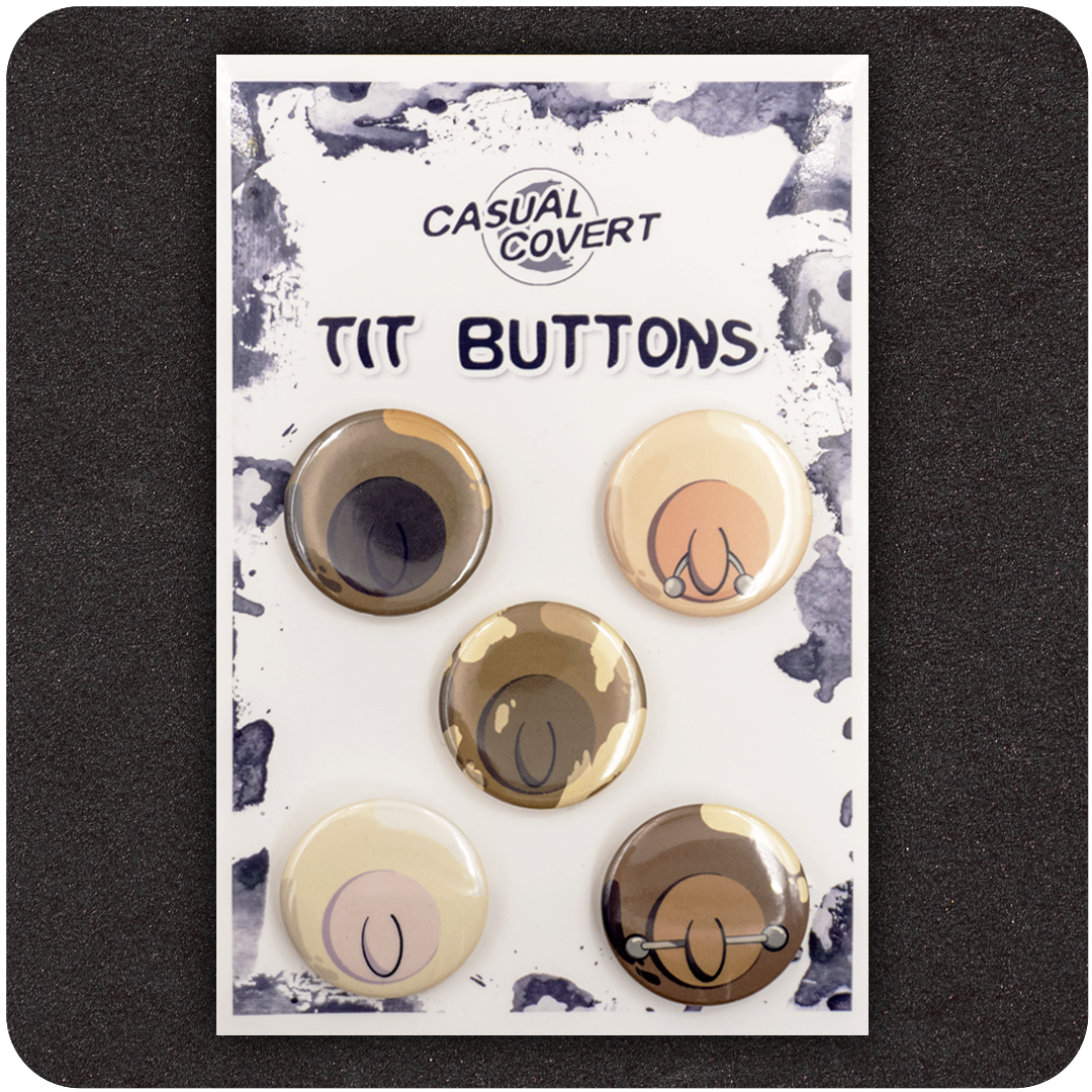 Casual Covert “Tit Buttons” pinback badge set featuring five cartoon-style nipple illustrations in diverse skin tones with playful variations, including piercings — humorous, body-positive accessory pack on branded card.