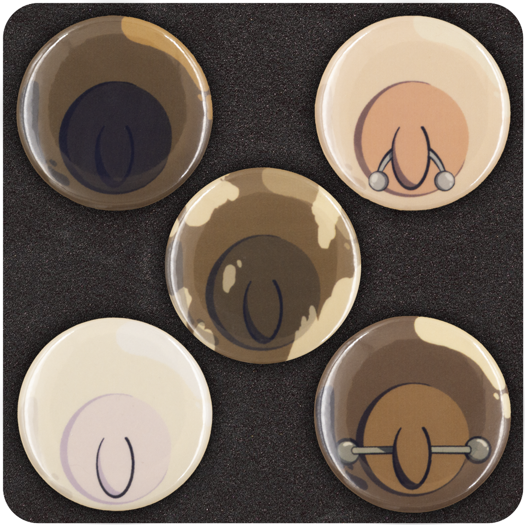 Close-up view of five Casual Covert “Tit Buttons” featuring minimalist nipple illustrations in various skin tones, including playful details like piercings and diverse shades — cheeky, inclusive enamel pinback button set.