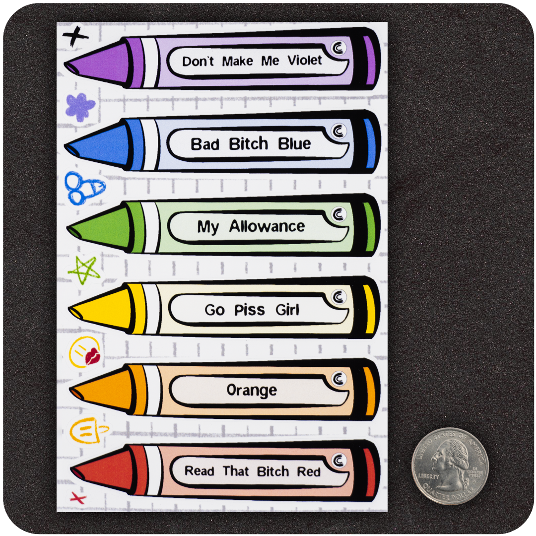 A sticker sheet featuring six colorful crayon-shaped stickers laid out vertically. Each crayon has a bold label with humorous names like “Don’t Make Me Violet,” “Bad Bitch Blue,” “My Allowance,” “Go Piss Girl,” “Orange,” and “Read That Bitch Red.” A U.S. quarter is placed next to the sheet for scale, showing the compact size of the stickers. The background mimics lined notebook paper, adding to the playful, school-supply parody theme.