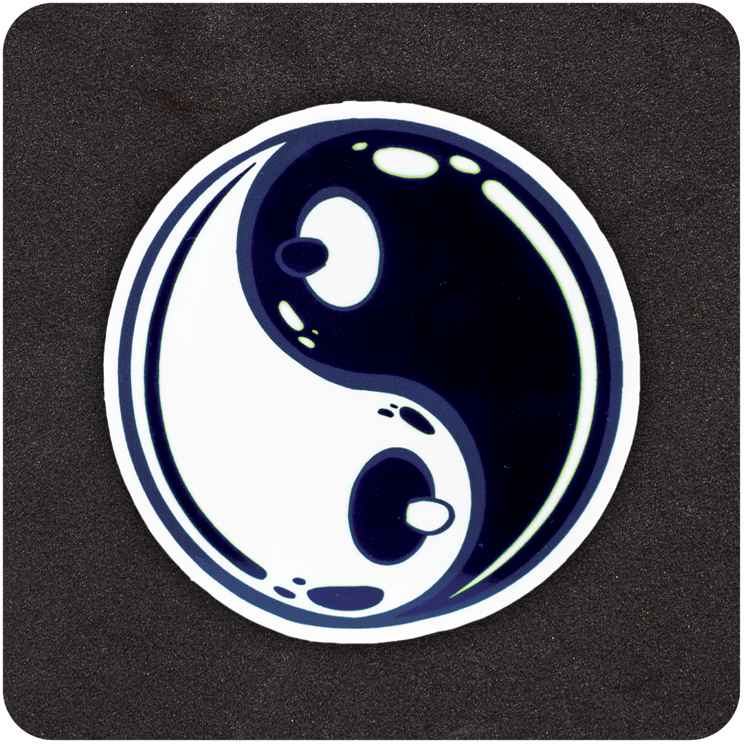 A circular sticker featuring a stylized yin-yang symbol on a black background. The traditional black and white teardrop shapes are subtly shaped to resemble cartoon breasts, with small nipples at the center of each dot. The design has a glossy, bubble-like finish with highlights to suggest shine and dimension.