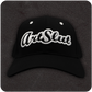 The Casual Covert Art Slut Snapback Hat. A black snapback hat with 3D white embroidery of the word "art slut" on the front of the cap.