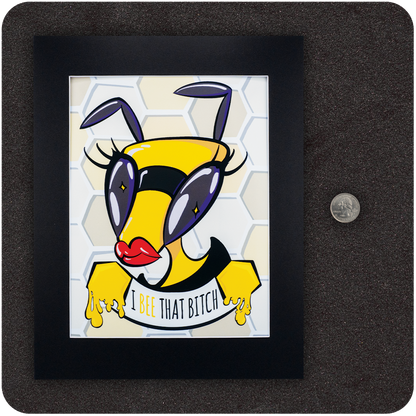 Framed art print of a fierce cartoon bee with oversized eyes, red lips, and honey-dripping hands holding a banner that reads “I Bee That Bitch.” Set against a honeycomb background with a U.S. quarter shown beside the frame for scale reference.