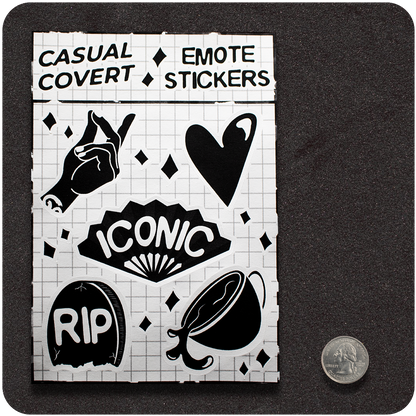 A sheet of black-and-white "Casual Covert Emote Stickers" displayed on a grid background. It includes six bold graphic icons: a snapping hand, a stylized dripping heart, a fan with the word "ICONIC," a tombstone marked "RIP," a tilted cup spilling liquid, and scattered diamond-shaped accents. A U.S. quarter is shown beside the sheet for scale.