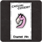 The Casual Covert Flamingo Enamel Pin on a backing card to show how the pin is packaged.