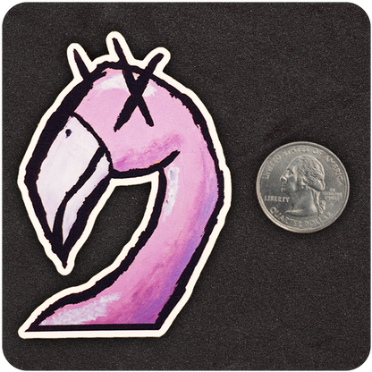A die-cut vinyl sticker featuring a stylized pink flamingo with exaggerated curves, bold black outlines, and cartoon-style Xs for eyes, set on a textured black background. A U.S. quarter is placed beside the sticker for scale, highlighting the compact size of the design.