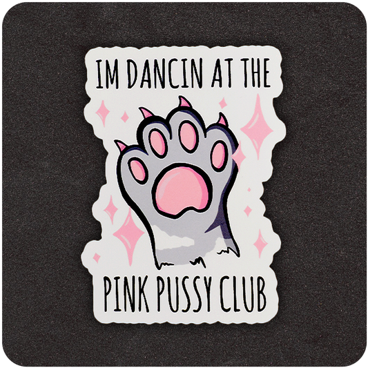 The Casual Covert I’m Dancin At The Pink Pussy Club Sticker. Shows a gray cat paw with pink sparkles and toe beans with the words "I’m Dancin At The Pink Pussy Club" around it.