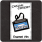 The Casual Covert Pussy Pop Enamel Pin on a backing card, showing how the pin is packaged. 