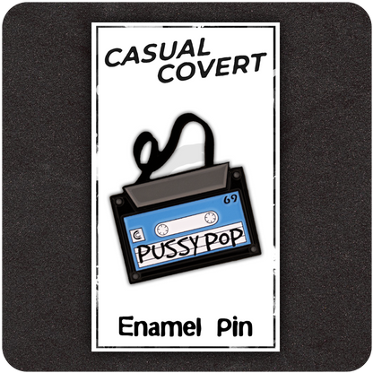 Pussy Pop Mixtape enamel pin on Casual Covert backing card, shaped like a retro cassette tape with black spooled ribbon and bold handwritten lettering.