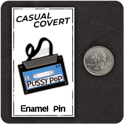 Pussy Pop Mixtape enamel pin displayed on branded Casual Covert backing card with a U.S. quarter for size reference; features a blue and black retro cassette design with loose tape.