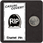 The Casual Covert RIP Enamel Pin next to a quarter to show it's size.