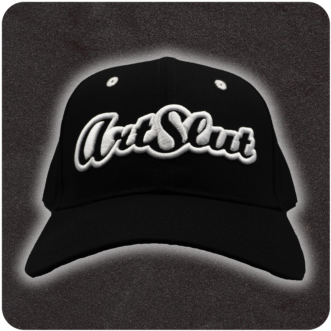 The Casual Covert Art Slut Snapback Hat. A black snapback hat with 3D white embroidery of the word "art slut" on the front of the cap.