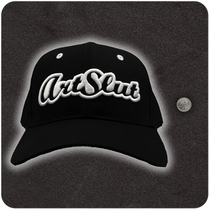 Casual Covert Art Slut Snapback Hat shown next to a quarter for relative scale. 