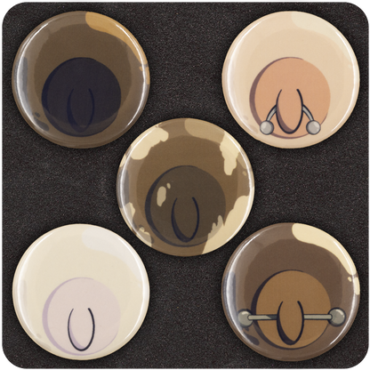 Close-up view of five Casual Covert “Tit Buttons” featuring minimalist nipple illustrations in various skin tones, including playful details like piercings and diverse shades — cheeky, inclusive enamel pinback button set.