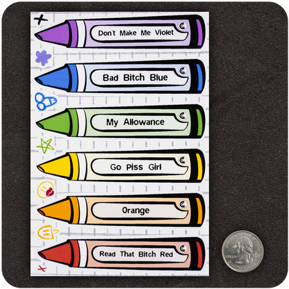 A sticker sheet featuring six colorful crayon-shaped stickers laid out vertically. Each crayon has a bold label with humorous names like “Don’t Make Me Violet,” “Bad Bitch Blue,” “My Allowance,” “Go Piss Girl,” “Orange,” and “Read That Bitch Red.” A U.S. quarter is placed next to the sheet for scale, showing the compact size of the stickers. The background mimics lined notebook paper, adding to the playful, school-supply parody theme.