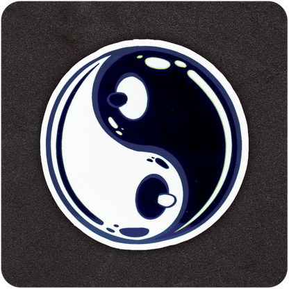 A circular sticker featuring a stylized yin-yang symbol on a black background. The traditional black and white teardrop shapes are subtly shaped to resemble cartoon breasts, with small nipples at the center of each dot. The design has a glossy, bubble-like finish with highlights to suggest shine and dimension.