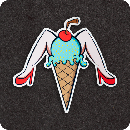A whimsical vinyl sticker featuring a light-skinned pin-up-style ice cream cone. The scoop is blue with yellow sprinkles, topped with a red cherry and a brown straw. The cone has a pair of pale legs in red high heels extending outward in a playful, retro pose. The design sits on a black background.