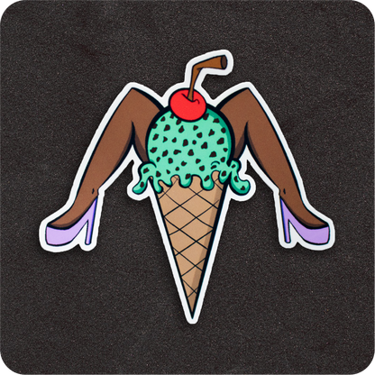 A playful vinyl sticker featuring a dark-skinned pin-up-style ice cream cone. The scoop is mint green with chocolate chips, topped with a bright red cherry and a brown straw. The cone has a pair of brown legs in lavender high heels striking a fun, cheeky pose. Displayed on a black background.